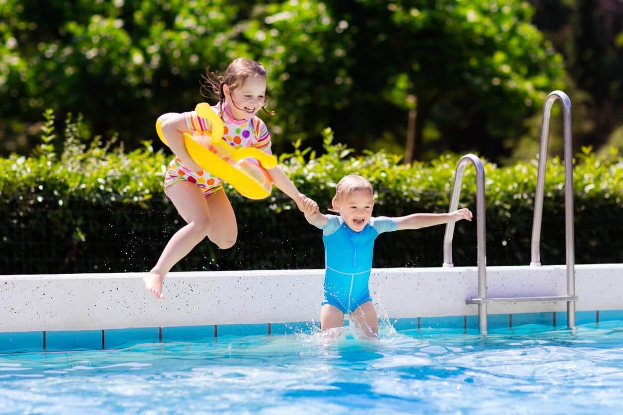 Happy Kids Jumping in Swimming Pool