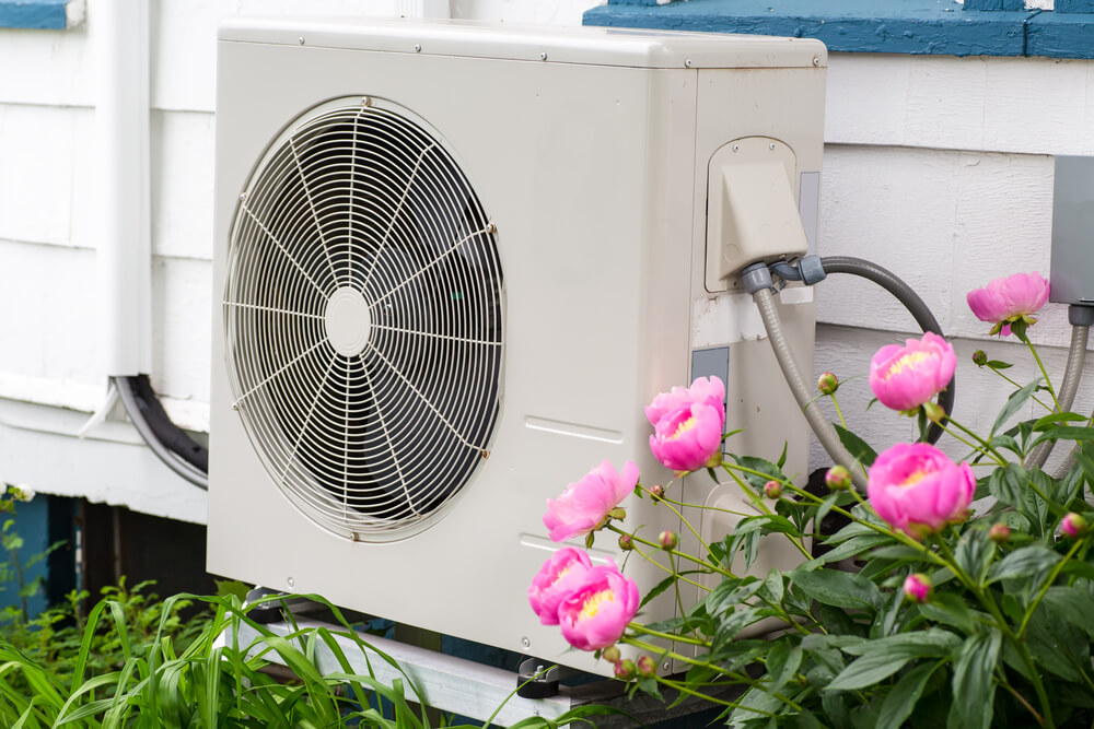Heat pump unit on the side of a home