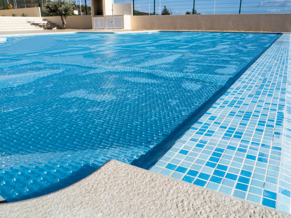 The cover of swimming pool which also lets the pool heat up from the sun.